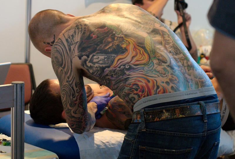 Tattoo artist at work by hennanights